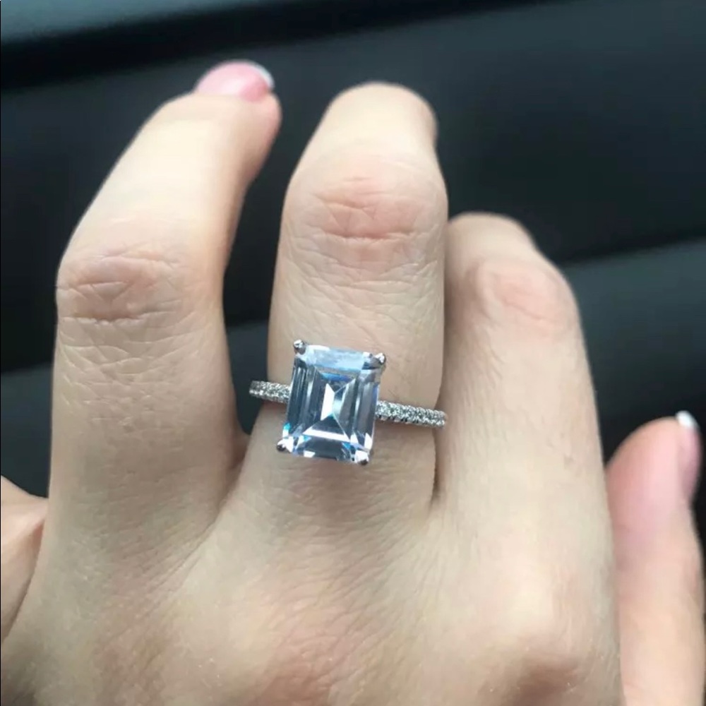 Pave band with a 3ct Emerald center stone